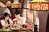Two diners raise their cans of Coca-Cola to a cheers at a restaurant in Itaewon, Yongsan District, central Seoul, on June 23. [COCA-COLA KOREA]