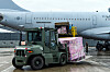 Soldiers load a military plane with face masks and other protective gear Thursday at an Air Force base in Gimhae, South Gyeongsang. Two KC-330 air refueling tankers departed that day for Iraq on a mission to bring home some 300 Korean construction workers. [YONHAP]