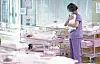 A staff at a post-natal care facility in Seoul holds a newborn baby to her chest on Dec. 26, 2023. President Yoon Suk Yeol proclaimed a nation-wide effort to raise Korea’s ever-falling birthrate in a meeting held on the same day. [YONHAP]