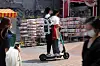 Two men illegally ride an e-scooter together in Hongdae, a lively suburb in Mapo District, western Seoul. [JOONGANG ILBO]