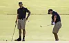 Adam Scott of Australia, left watches as Kim Joo-hyung chips onto the sixth green during a practice round for the 2022 Presidents Cup at the Quail Hollow Club in Charlotte, North Carolina, on Tuesday. [EPA/YONHAP]