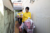 First lady Kim Keon-hee delivers donations to residents of so-called jjokbangchon, a cluster of single-rooms rented to low-income people, in Busan as part of a volunteer work with the Korea Saemaul Undong Center’s Busan branch on Thursday. According to the President’s office, the first lady joined a group of college student volunteers. [PRESIDENTIAL OFFICE]