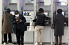 Bank customers use ATMs in Seoul on Dec. 27. [NEWS1]