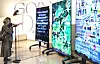 Visitors look at artist Stephanie Dinkins' artworks dubbed 'The Stories We Tell Our Machines, work in progress' displayed through LG's OLED panels presented at the New York-based Guggenheim Museum. [ED MARSHALL]