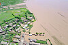 A village in North Hwanghae Province, one of North Korea's most important grain-producing areas, is shown heavily flooded in state media footage from July. The downpours, and the pandemic, aggravated the country's food insecurity this year, but Pyongyang refuses to accept help. [YONHAP]