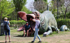 Foreign tourists take photos with the sculpture of the monster featured in the 2006 Korean film ″The Host″ at Hangang Park in Yeouido, western Seoul, on Thursday. The Seoul Metropolitan Government said the same day it will decide on the removal of the sculpture after holding a meeting with a public art review committee next month. [NEWS1]