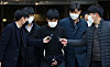 Son Jong-woo, third from left, is questioned by reporters after exiting a court hearing for a detention warrant, which was denied on Monday evening. Son is a convicted distributor of child pornography. [YONHAP]