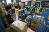 Delivery workers sort packages at a warehouse in Songpa District, southern Seoul, on Sept. 3. [NEWS1]