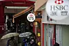 Pedestrians wearing face masks following the Covid-19 outbreak, walk past a HSBC bank branch in Hong Kong on Feb. 22, 2022. [REUTERS/YONHAP]