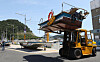 A forklift lifts a boat. The forklift truck is moving the boat to land. [NEWS1]