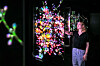 A visitor looks at the 'Blooming Strings' media artwork which utilizes LG Display's transparent OLED panel at Artechouse in Washington D.C. [LG CORP.]