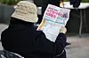 A job seeker reads a flyer at a job fair for seniors held in western Seoul on Dec. 15, 2022. [YONHAP]
