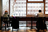 Customers at a coffee chain in Jung District, central Seoul, are drinking coffee indoors while maintaining distance on Jan. 18, when the relaxed social distancing measures started to permit indoor dining at coffee chains. [JANG JIN-YOUNG]