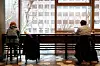Customers at a coffee chain in Jung District, central Seoul, are drinking coffee indoors while maintaining distance on Jan. 18, when the relaxed social distancing measures started to permit indoor dining at coffee chains. [JANG JIN-YOUNG]