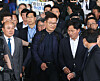 Former Democratic Party leader Song Young-gil is surrounded by reporters as he exits immigration at Incheon International Airport on Monday. [YONHAP]