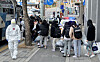 Students who were diagnosed with the coronavirus at the IEM School in Daejeon, a Christian missionary training school, board a bus Monday to be transferred to a nearby life treatment center for Covid-19 patients with mild or no symptoms. [KIM SEONG-TAE]