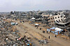 People walk amid collapsed buildings along Saftawi street in Jabalia in the northern Gaza Strip on Feb. 5 during a ceasefire deal in the war between Israel and Hamas. Palestinian militant group Hamas lashed out on Feb. 5, at President Donald Trump's shock proposal for the United States to take over the Gaza Strip and resettle its people in other countries, seemingly whether they want to leave or not. [AFP/YONHAP]