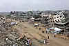 People walk amid collapsed buildings along Saftawi street in Jabalia in the northern Gaza Strip on Feb. 5 during a ceasefire deal in the war between Israel and Hamas. Palestinian militant group Hamas lashed out on Feb. 5, at President Donald Trump's shock proposal for the United States to take over the Gaza Strip and resettle its people in other countries, seemingly whether they want to leave or not. [AFP/YONHAP]