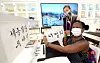 A visitor to the Korea Pavilion poses for a photo after learning about Korean calligraphy on Oct. 1. [KOREA TRADE-INVESTMENT PROMOTION AGENCY]