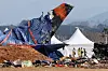 Firefighters look around an accident site where Jeju Air's Boeing 737-800 crashed in Muan International Airport in South Jeolla on Jan. 12. [YONHAP]