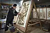 Kim Yeong-jo, who is designated as a national intangible cultural asset due to his knowledge on the techniques of creating nakhwa paintings, which uses a heated iron instead of a brush, works at his studio in Boeun, North Chungcheong. [PARK SANG-MOON]