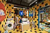 There is also a washing machine in a separate room, with clothes hung on a clothesline. Clothes are scattered across the floor, creating a messy appearance. [STORAGE BY HYUNDAI CARD]