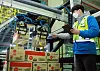 A CJ Logistics worker demonstrates an AI robot depalletizer at a fulfilment center in Dongtan, Gyeonggi. [CJ LOGISTICS]