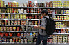 A consumer shops at the section of instant noodle products at a supermarket in Seoul on Monday. [YONHAP]