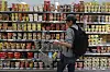 A consumer shops at the section of instant noodle products at a supermarket in Seoul on Monday. [YONHAP]