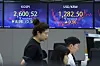 Screens in Hana Bank's trading room in central Seoul show stock and foreign exchange markets open on Tuesday. [YONHAP]