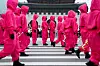 Performers dressed as “Squid Game” (2021-25) soldiers march in a parade through central Seoul, followed by a fan event with cast to celebrate the release of the third season of Netflix's hit series, in Seoul, on June 28, 2025. [REUTERS/YONHAP]