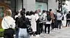 Customers wait in line in front of a luxury brand at a department store in Seoul on Sunday. [NEWS1]