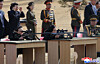 Kim Yo-jong, left, takes aim with a rifle at a firing range on Feb. 27 in this photo carried by the North's official Korean Central News Agency the following day. [YONHAP]