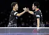 Lim Jong-hoon, left, and Jang Woo-jin celebrate during the men's doubles semifinal match against Japan's Togami Shunsuke and Uda Yukiya at the 2021 World Table Tennis Championships Finals in Houston, Texas, on Sunday. [XINHUA/YONHAP]
