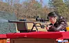 North Korean leader Kim Jong-un's daughter Ju-ae takes aim at a target with a sniper rifle at a firing range on Feb. 27 in this photo carried by the North's official Korean Central News Agency the following day. [YONHAP]