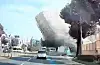 In this image from a car's black box, a five-story building collapses during demolition and falls on a bus in Gwangju on Wednesday. [NEWS1]