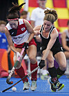 Korea's Seo Jung-eon, left, fights for the ball with Canada's Natalie Sourisseau during an FIH Women's Hockey World Cup match in Terrassa, Spain on Sunday. Korea won the game 3-2, moving into third place in Group C on goal difference. [EPA/YONHAP]