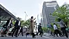 Office workers head to work from the subway at Yeouido Station in Yeouido, western Seoul, in May. [YONHAP]