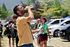 A participant of the 25th World Scout Jamboree held at Saemangeum in Buan County, North Jeolla, quenches his thirst on Tuesday as nationwide temperatures reached 32 to 36 degrees Celsius (90 to 97 degrees Fahrenheit). [YONHAP]