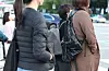 People wearing jackets and outerwear stand on streets in Jongno District, central Seoul, on Wednesday morning. [NEWS1]