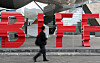 A passerby walks across the Busan International Film Festival (BIFF) logo in front of the Busan Cinema Center in Haeundae District, eastern Busan, on Wednesday. [YONHAP]