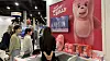 Foreign buyers look around the Bellygom booth installed at the Licensing Expo 2023 in Las Vegas on Tuesday. Bellygom, the pink teddy bear character created by Lotte Home Shopping, made its debut at the Licensing Expo and secured export contracts for fashion items such as T-shirts and swimwear. With over 70 countries and 300 companies participating, the Licensing Expo is the world's largest licensing trade show for characters and brands, held from Tuesday through Thursday. [LOTTE HOME SHOPPING]