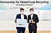 Hur Sung-woo, right, executive vice president of LG Chem's petrochemical global business development team, and Ryan Brown, left, vice president of environment health & safety at Coupang, pose for a photo with plastic pellets and bags that have been produced from plastic waste after signing an agreement Thursday. [LG CHEM]