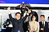 Lee Jae-myung and his wife Kim Hye-kyung celebrate on stage in Yeouido, central Seoul in the early hours of the morning on June 4. [JOINT PRESS CORPS]