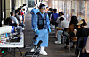 Medical workers help people line up for virus tests at a screening center in Songpa District, southern Seoul, on Tuesday. [NEWS1]