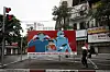 A woman walks past a sign about the Covid-19 pandemic in Hanoi, Vietnam, on April 23, 2020. Communist propaganda, which was most visible during the Vietnam War, has been revived in recent weeks as artists contribute to the national effort to fight the coronavirus. [EPA/LUONG THAI LINH/YONHAP]