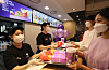 Customers purchase ″The BTS Set,″ McDonald's latest offering in collaboration with BTS, at McDonald's Coex branch on Thursday. [YONHAP]