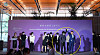 Presidential office policy coordination officer Jang Sung-min holds up BTS member V's arms during a ceremony appointing the boy band as ambassadors for Busan's bid to host the 2030 World Expo, held at HYBE's office in Yongsan District, central Seoul, Tuesday. [SCREEN CAPTURE]