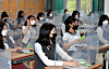 Seniors at Jeonmin High School in Daejeon sit at desks with plastic dividers on Wednesday. Schools reopened for the first time for high school seniors Wednesday since the coronavirus pandemic. [KIM SEONG-TAE]