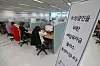 Call center employees in Daejeon handle inquires on the fourth emergency relief grants for small businesses on Tuesday. The emergency relief grants for small neighborhood shops, using funds created through this year’s first supplementary budget approved last week, started to accept applicants on Tuesday. [YONHAP]